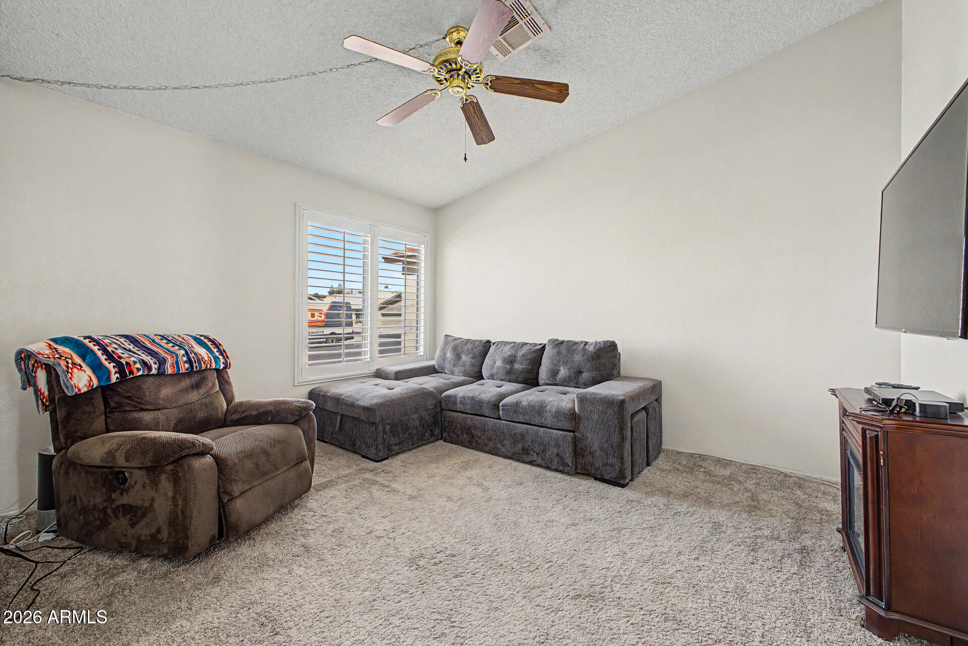 2659 West Hearn Road Phoenix, AZ 85023 - Photo 7 of 25 a living room with furniture a ceiling fan and a window
