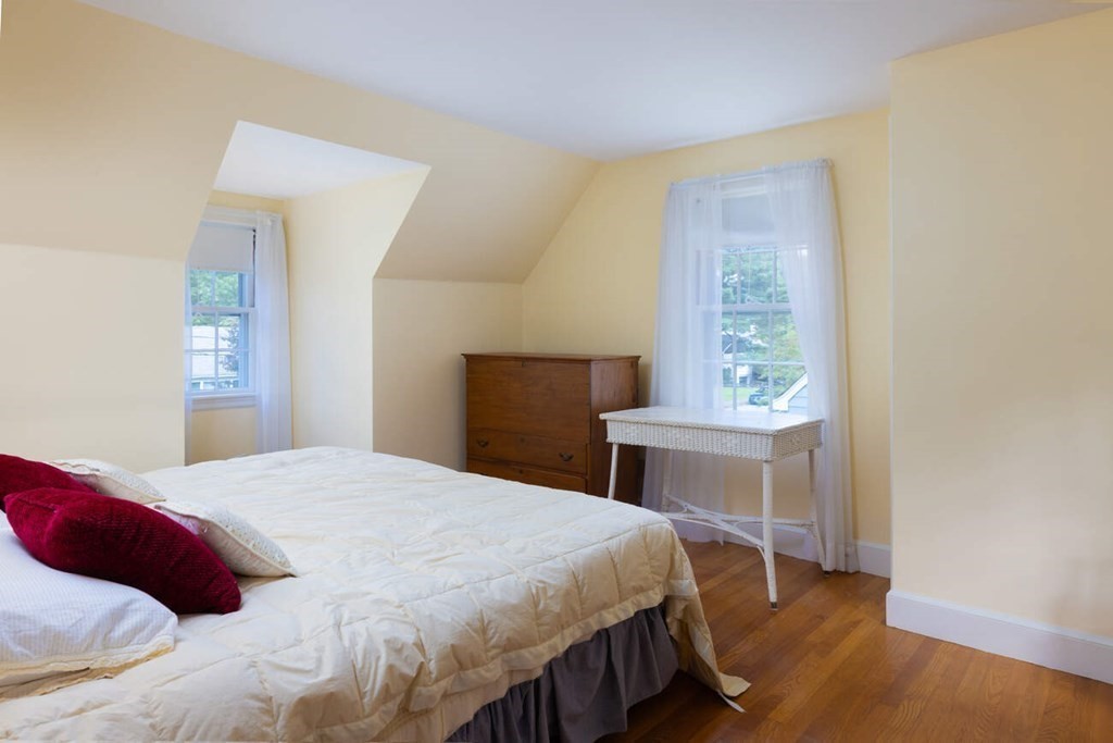 54 Bound Brook Road Newton, MA 02461 - Photo 12 of 14 a bedroom with a bed and a table in it