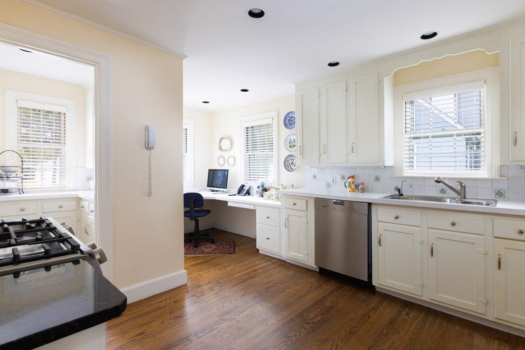54 Bound Brook Road Newton, MA 02461 - Photo 6 of 14 a kitchen with a sink stove and white cabinets