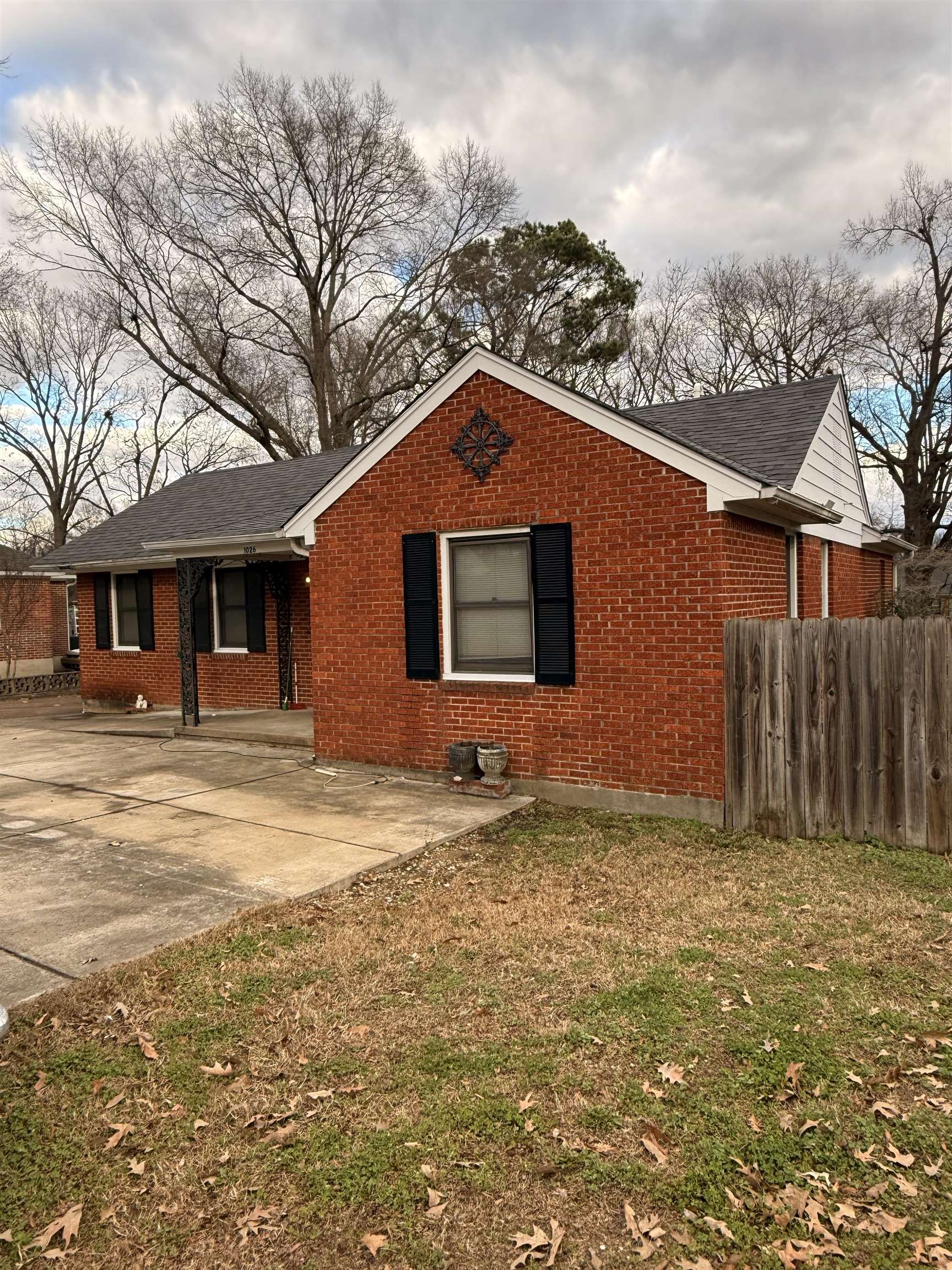 View of front of house with brick siding and a shingled roof