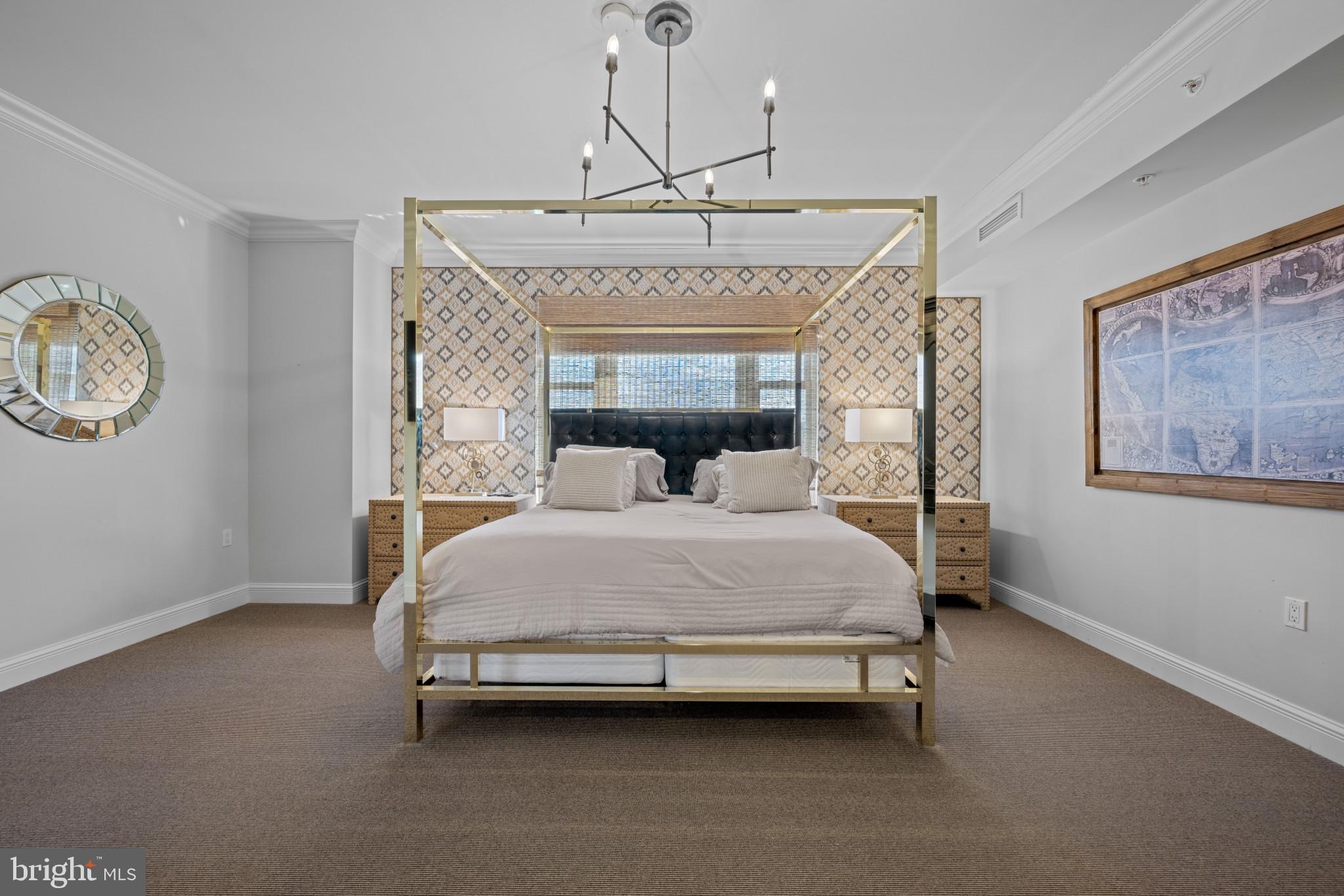 801 Key Highway, Unit 458 Baltimore, MD 21230 - Photo 20 of 48 a bedroom with a bed and a chandelier