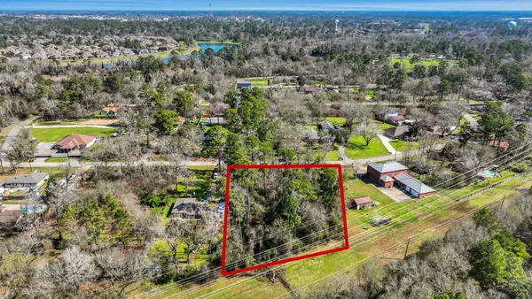 an aerial view of a houses with a yard