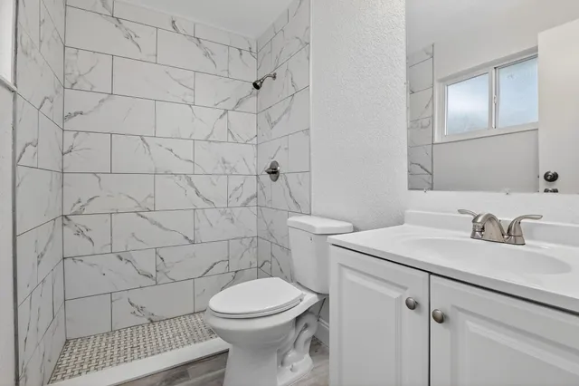 a bathroom with a sink toilet and shower