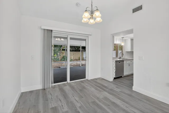 a view of a kitchen with wooden floor and a kitchen