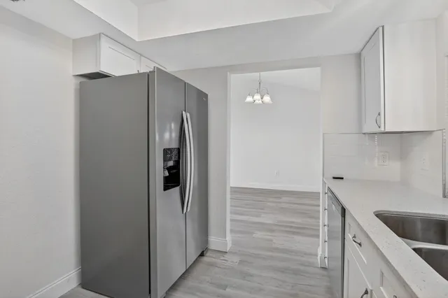 a kitchen with a refrigerator and cabinets