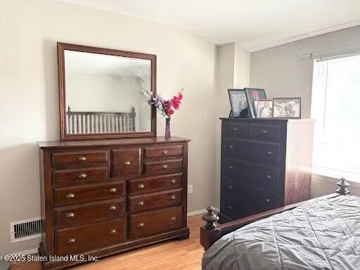 a bedroom with a bed and a dresser