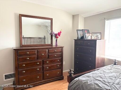 12 Delmar Avenue, Unit A Staten Island, NY 10312 - Photo 11 of 19 a bedroom with a bed and a dresser