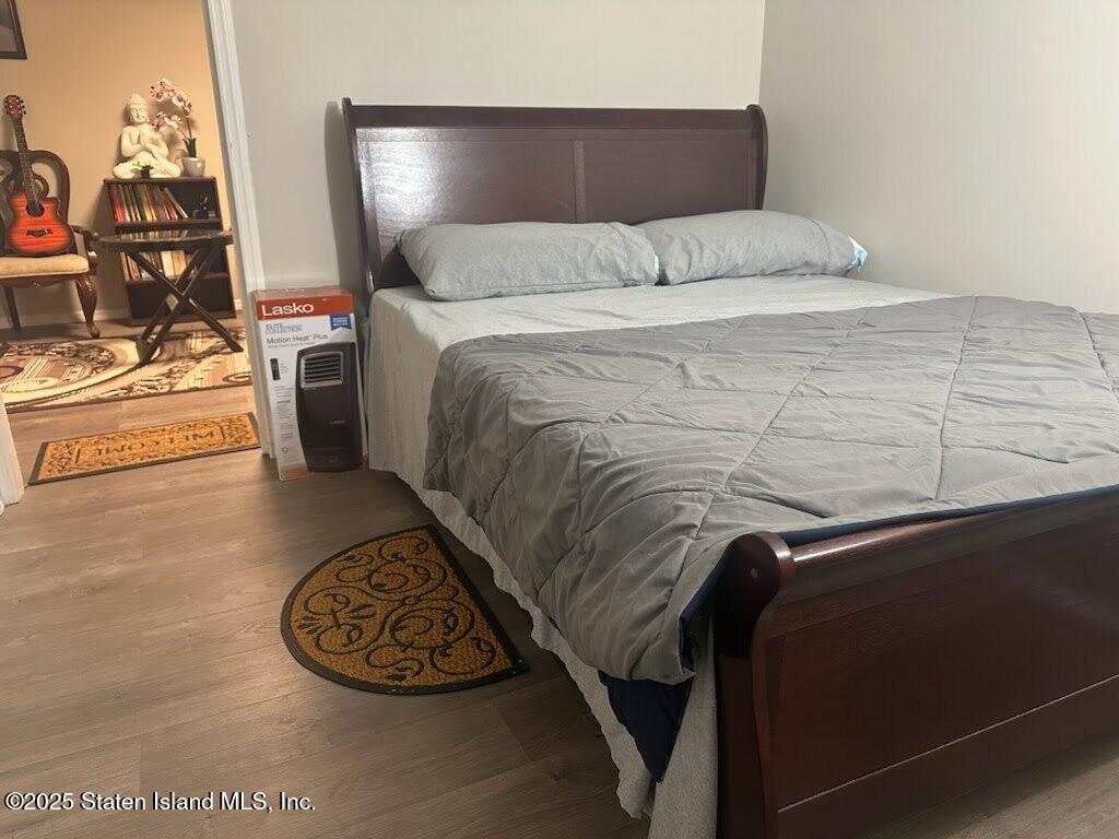 12 Delmar Avenue, Unit A Staten Island, NY 10312 - Photo 14 of 19 a bed with a white comforter and pillows