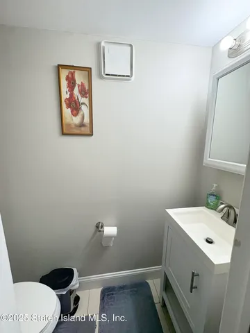 a bathroom with a toilet a sink and mirror