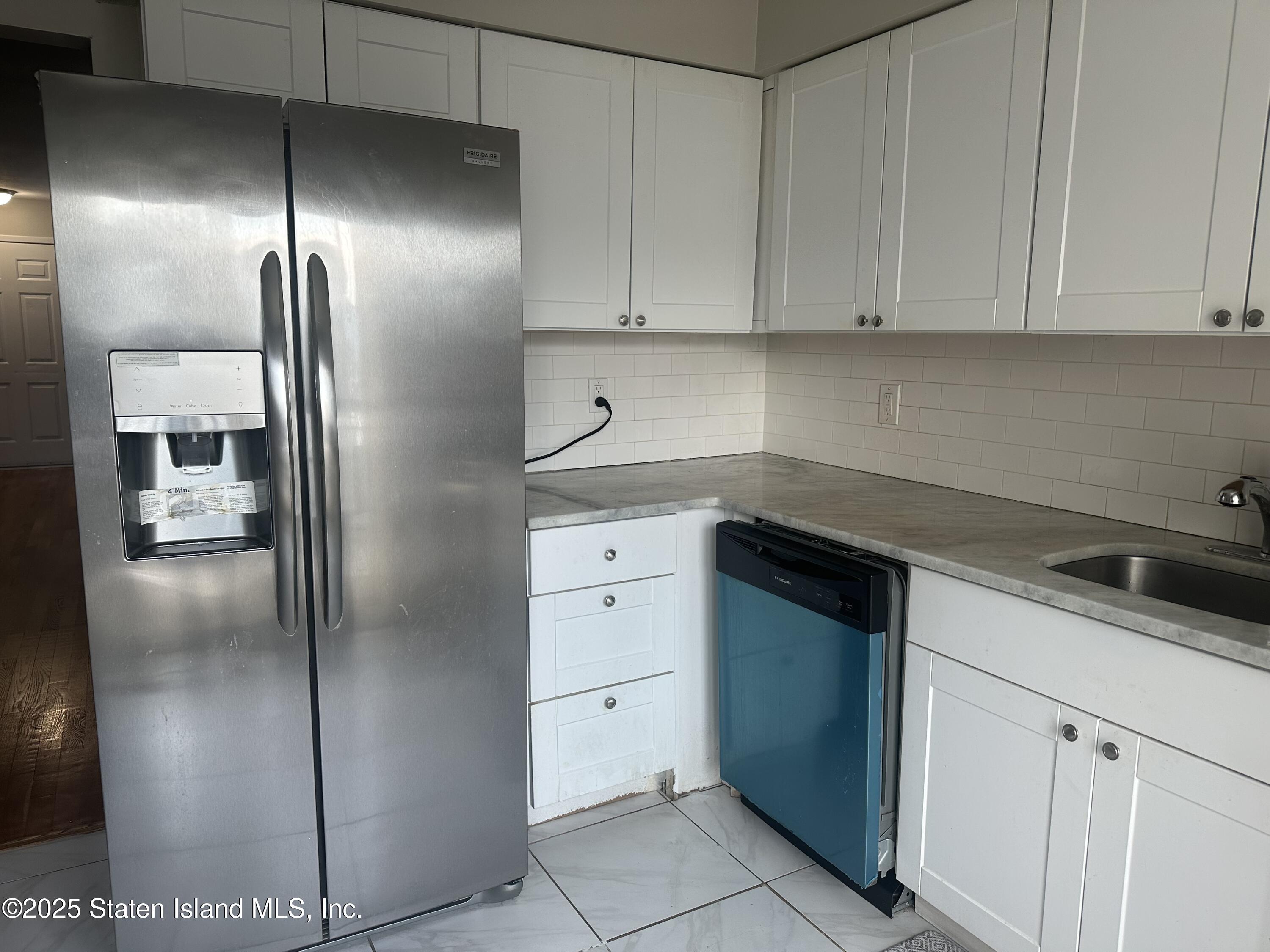 12 Delmar Avenue, Unit A Staten Island, NY 10312 - Photo 2 of 19 a kitchen with cabinets and stainless steel appliances