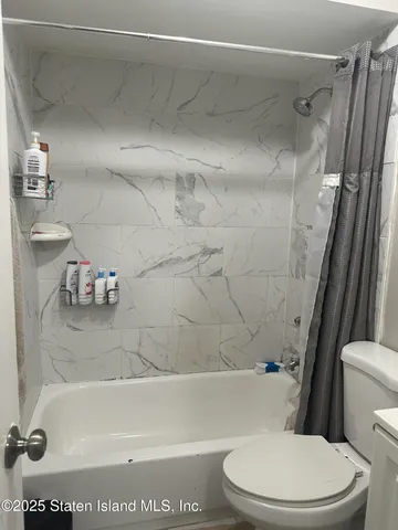 a bathroom with a sink a toilet and a bathtub