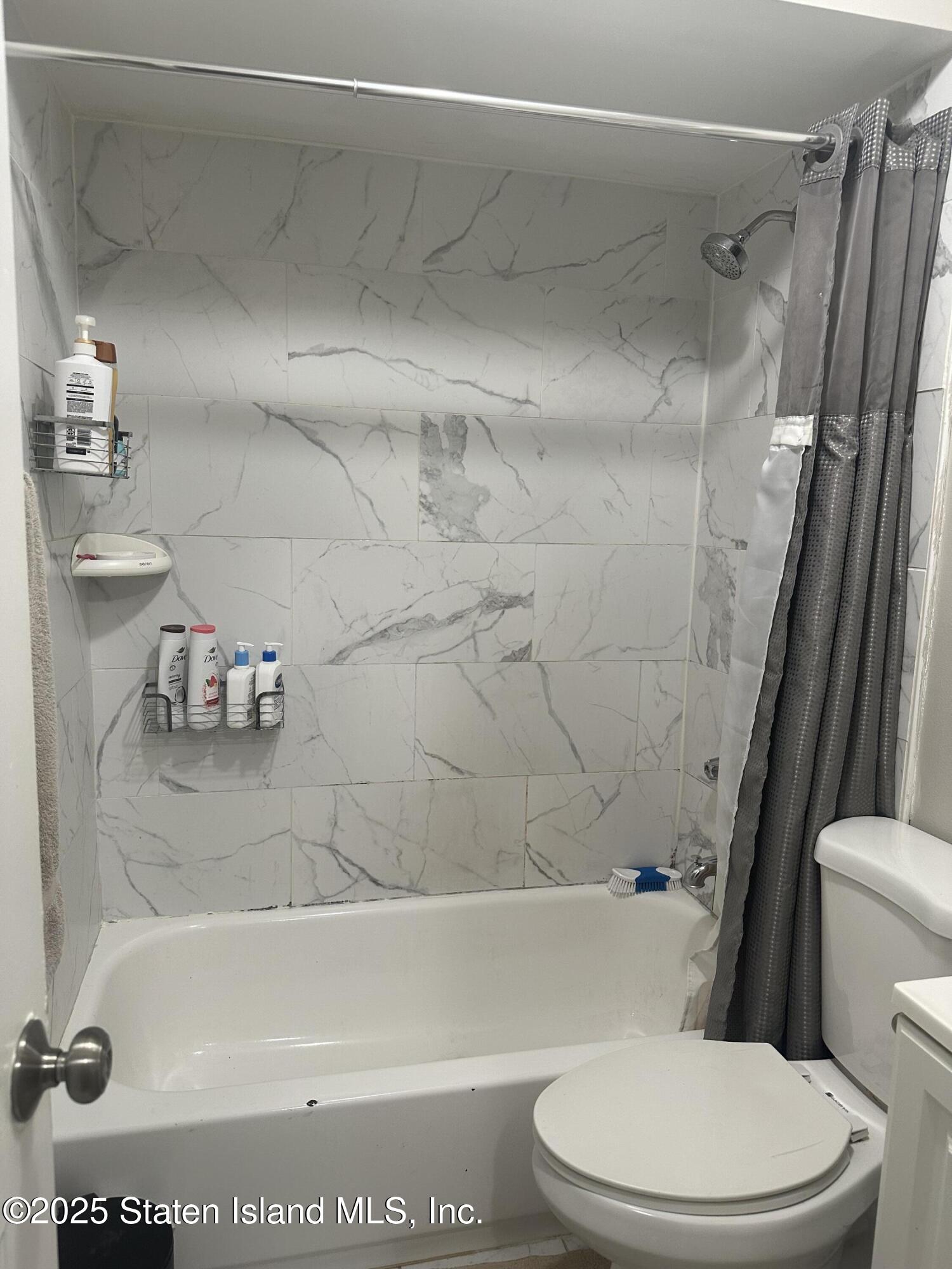 12 Delmar Avenue, Unit A Staten Island, NY 10312 - Photo 8 of 19 a bathroom with a sink a toilet and a bathtub