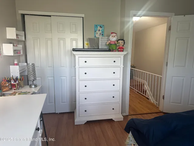 a bedroom with a baby crib and dresser