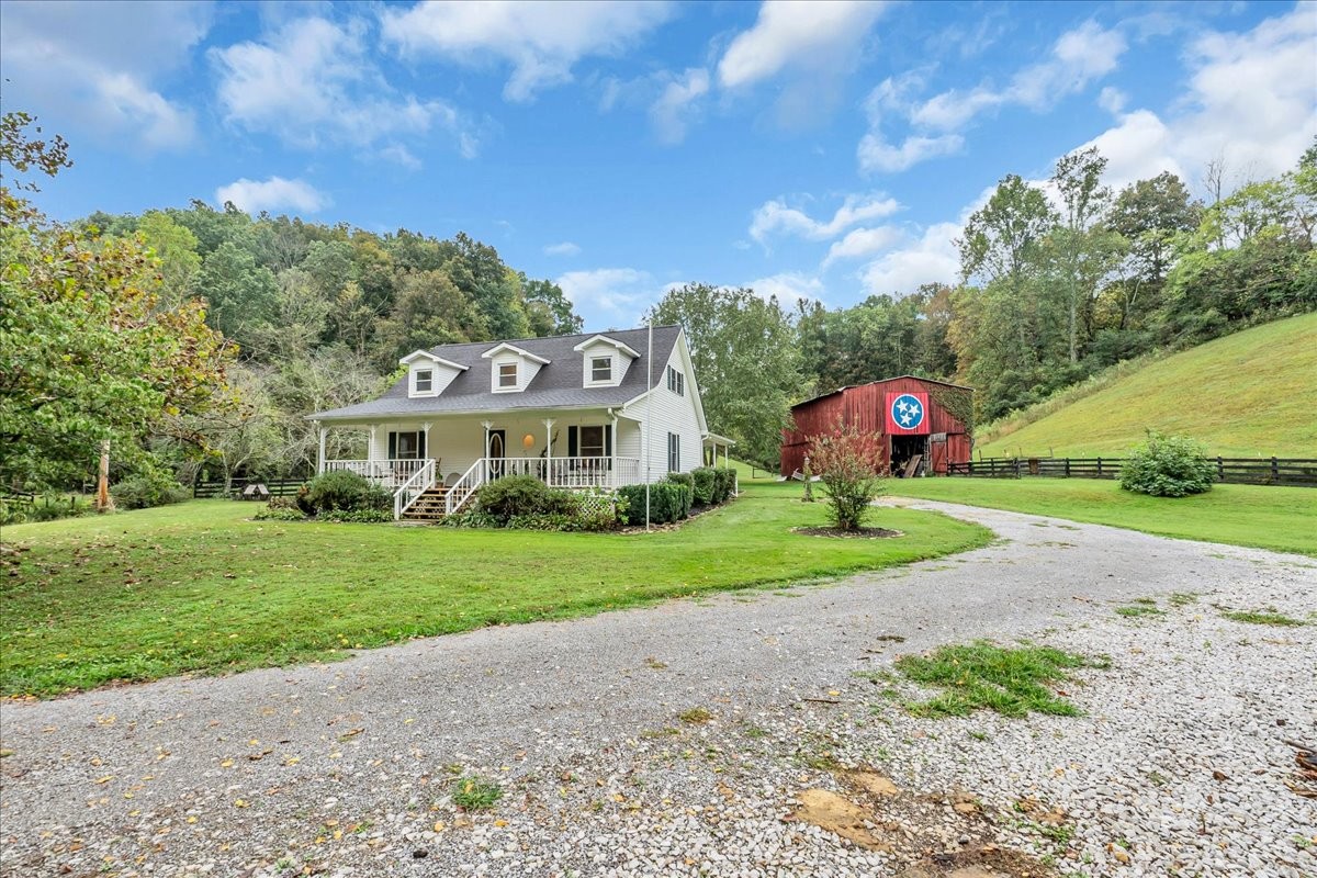 830 Bobo Hollow Road Lynchburg, TN 37352 - Photo 2 of 71 a view of a big house with a big yard and potted plants