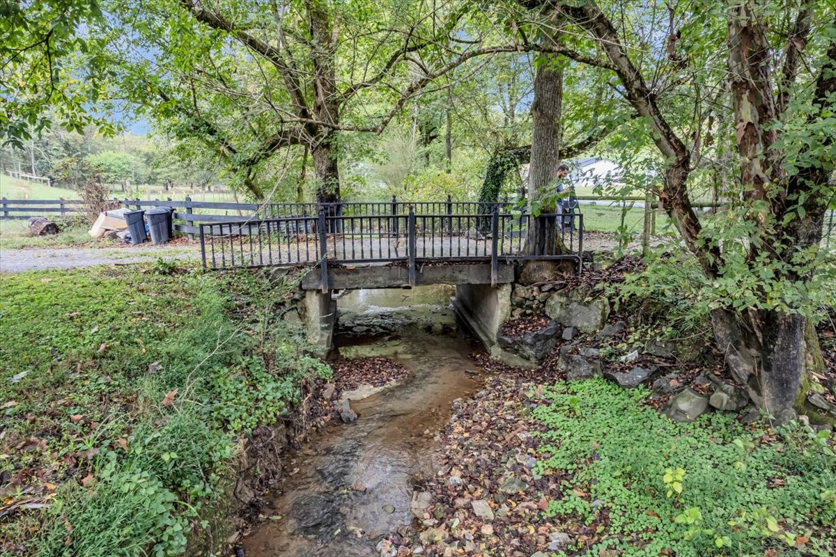830 Bobo Hollow Road Lynchburg, TN 37352 - Photo 3 of 71 a view of a yard with large trees and a wooden fence