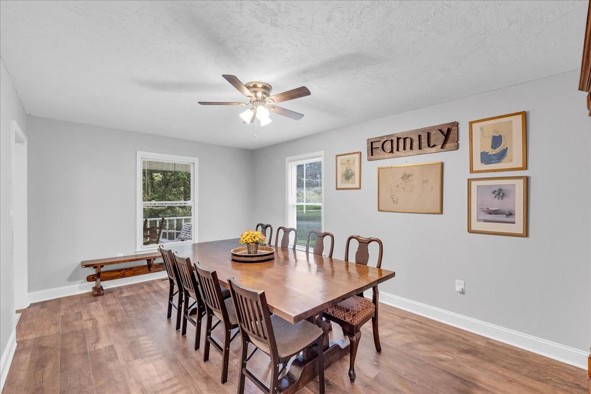 830 Bobo Hollow Road Lynchburg, TN 37352 - Photo 35 of 71 a view of a dining room with furniture window and wooden floor
