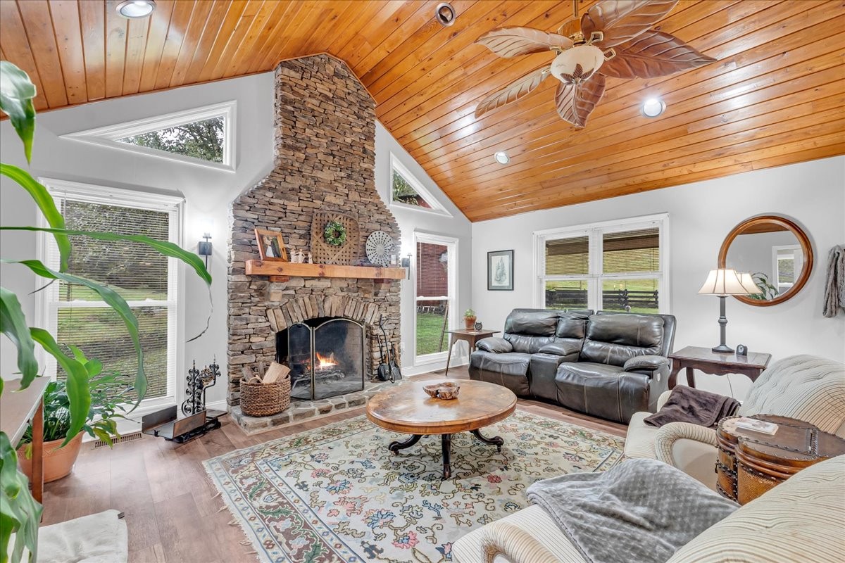 830 Bobo Hollow Road Lynchburg, TN 37352 - Photo 40 of 71 a living room with furniture a window and a fireplace