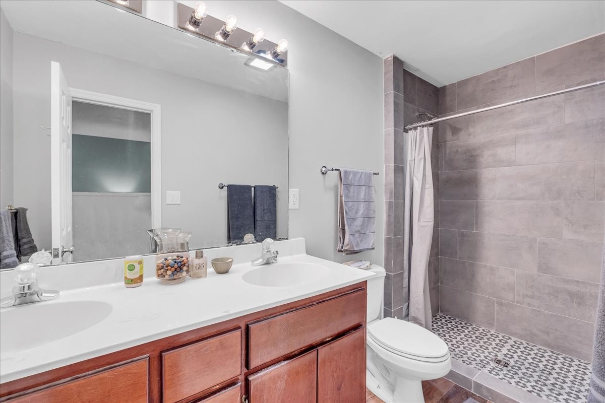 830 Bobo Hollow Road Lynchburg, TN 37352 - Photo 51 of 71 a bathroom with a sink toilet double vanity and shower