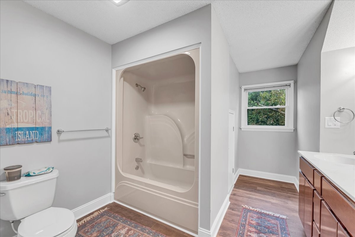 830 Bobo Hollow Road Lynchburg, TN 37352 - Photo 58 of 71 a bathroom with a granite countertop toilet a sink and bathtub