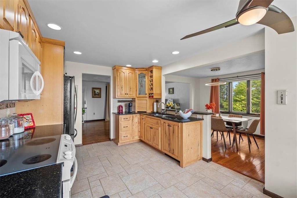 138 Stepp Road Sarver, PA 16055 - Photo 11 of 46 a kitchen with stainless steel appliances kitchen island granite countertop a stove a sink and a refrigerator
