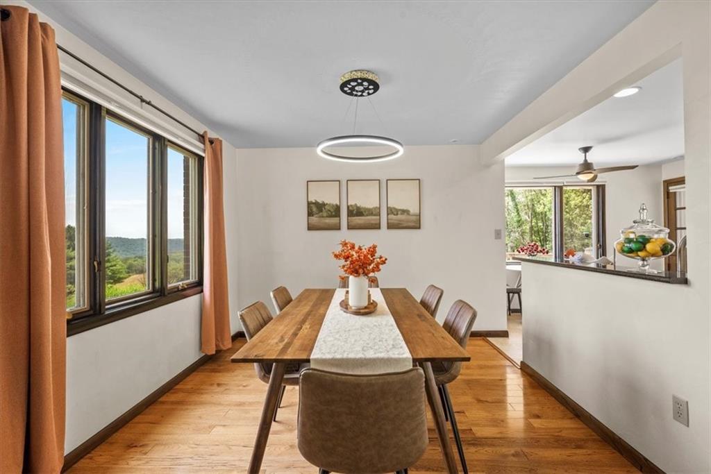 138 Stepp Road Sarver, PA 16055 - Photo 8 of 46 a view of a dining room with furniture a chandelier and wooden floor