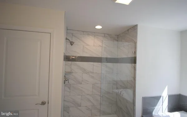 a bathroom with a shower and a glass door