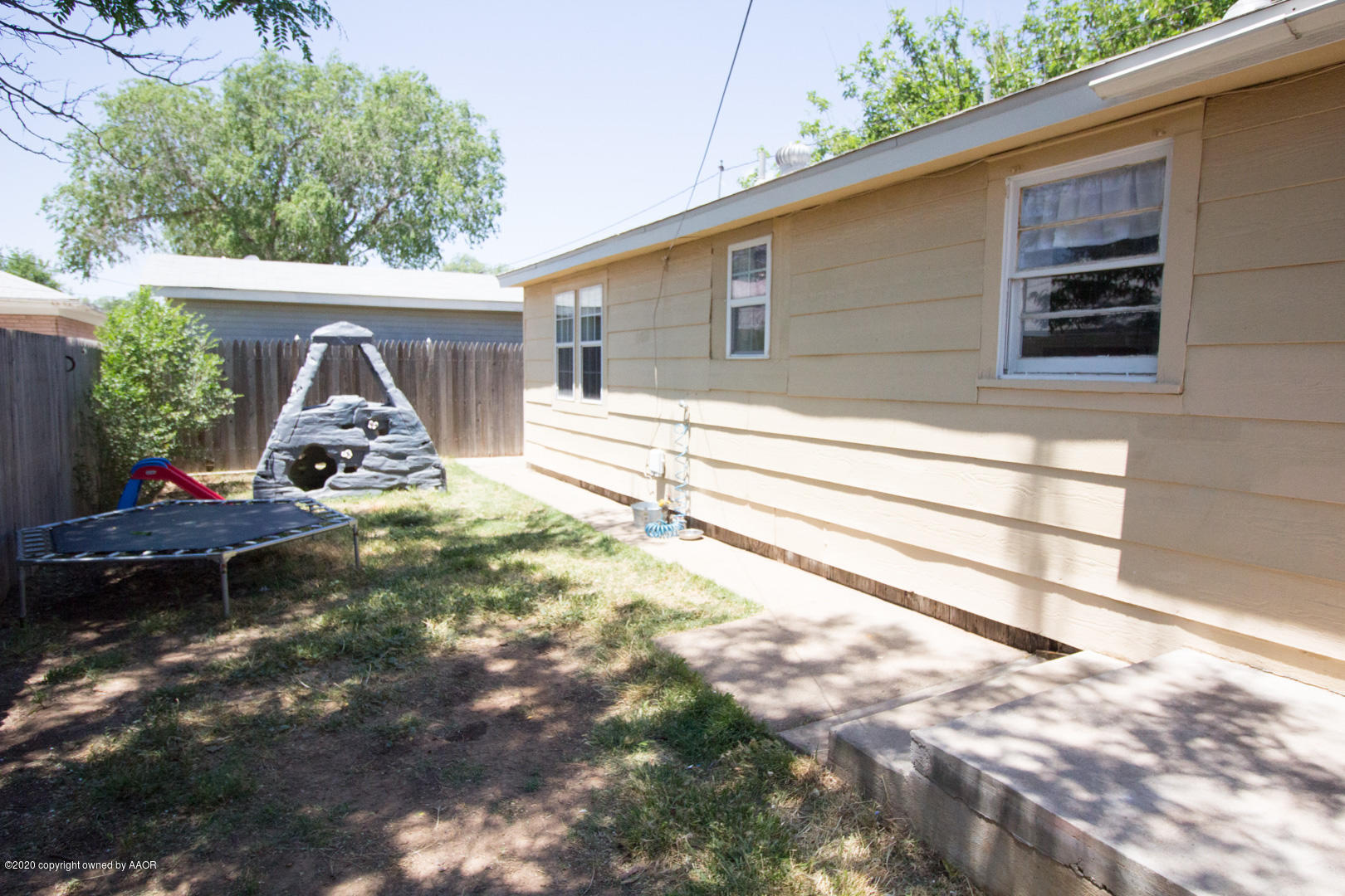 313 Southwest 38th Avenue Amarillo, TX 79110 - Photo 19 of 22 a view of backyard with wooden fence and large trees