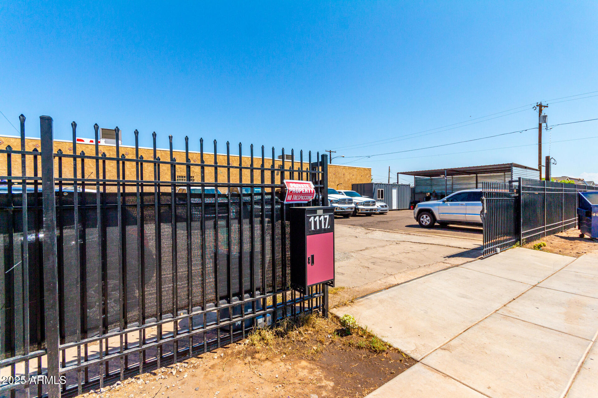 1117 West Buckeye Road, Unit 5 Phoenix, AZ 85007 - Photo 32 of 32 a cars parked on a sidewalk next to a building