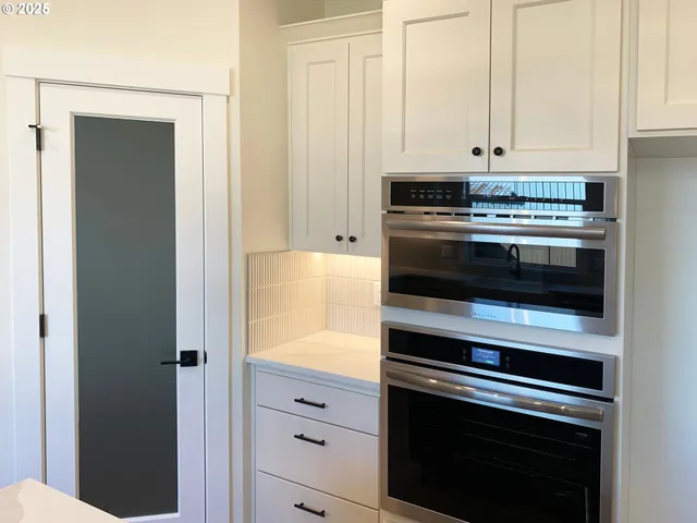 a kitchen with appliances and cabinets