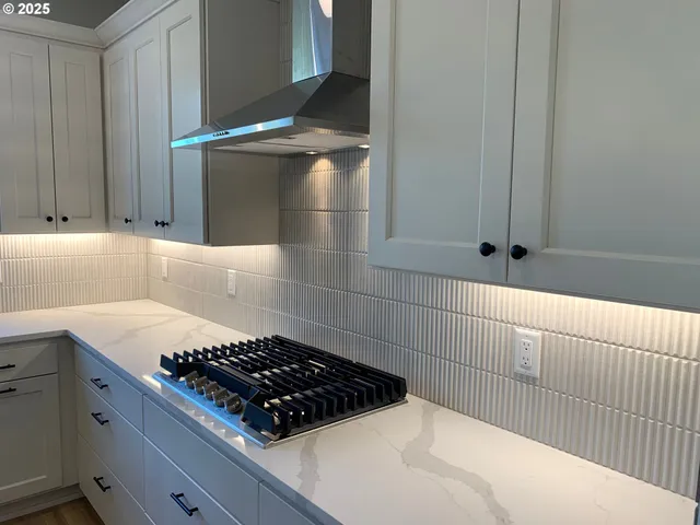 a kitchen with a white stove and a sink