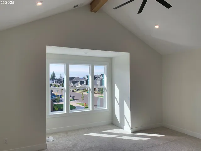 a view of a livingroom with a ceiling fan and window