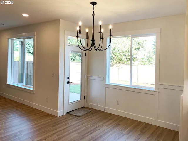 a view of an entryway with wooden floor windows