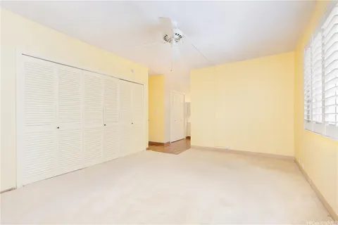 a spacious bathroom with a double vanity sink a toilet and a mirror