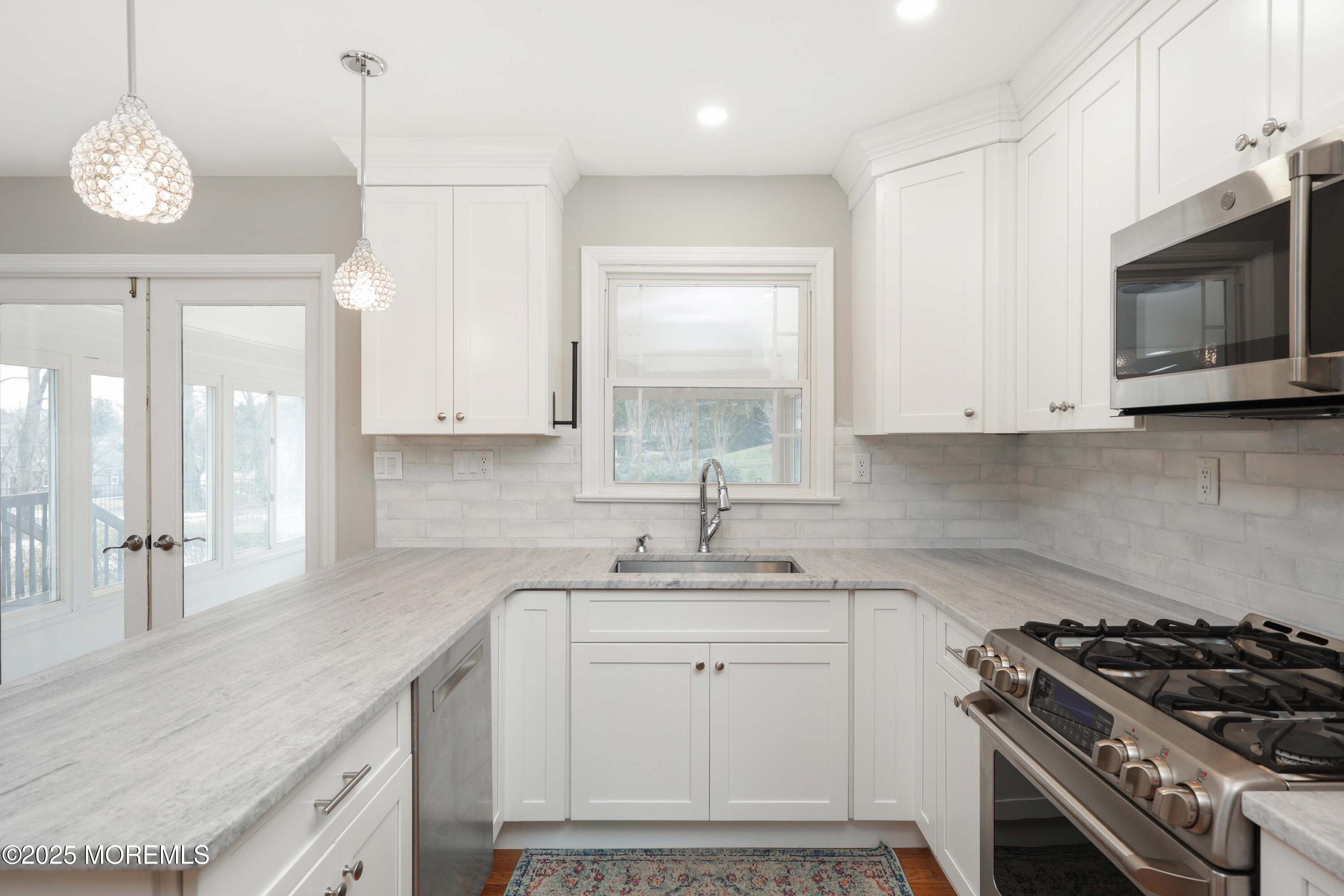 6 Hawthorne Road Red Bank, NJ 07701 - Photo 11 of 40 a kitchen with stainless steel appliances a stove a sink and a white cabinets