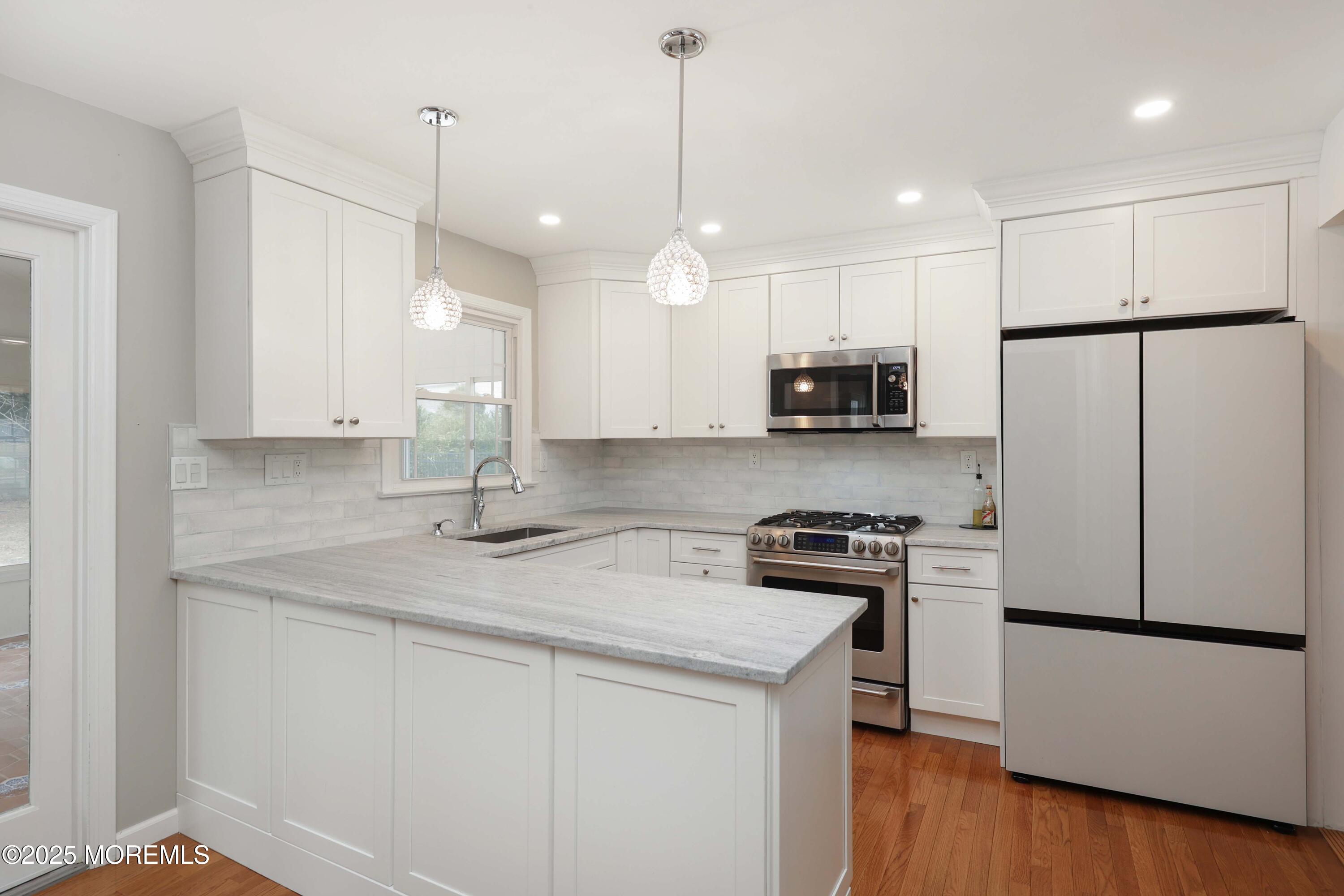 6 Hawthorne Road Red Bank, NJ 07701 - Photo 12 of 40 a kitchen with granite countertop white cabinets and stainless steel appliances