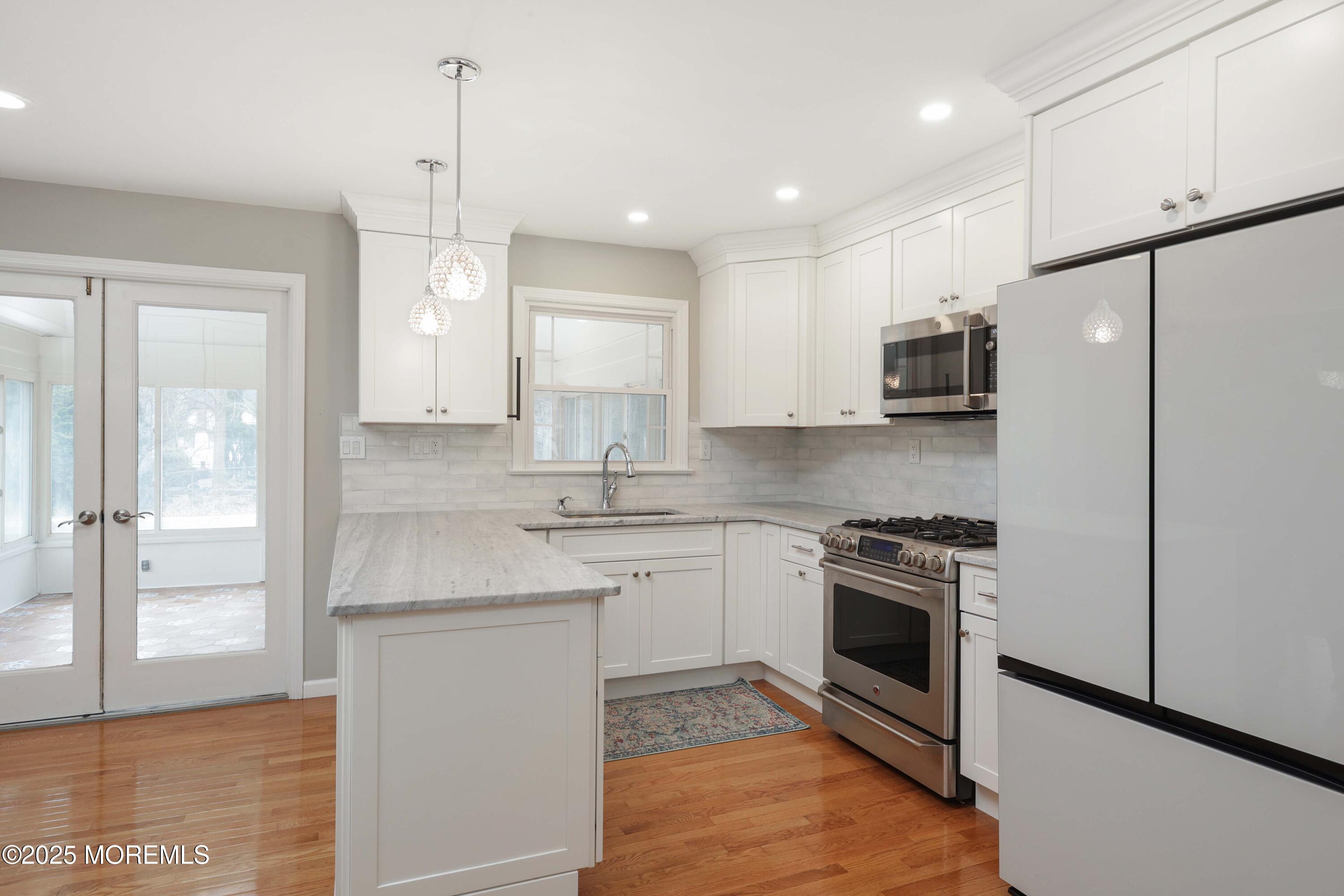 6 Hawthorne Road Red Bank, NJ 07701 - Photo 10 of 40 a kitchen with stainless steel appliances granite countertop a stove a sink and a refrigerator