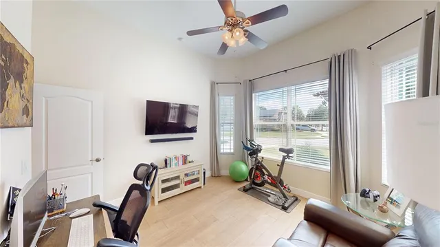 a view of a livingroom with workspace and a window