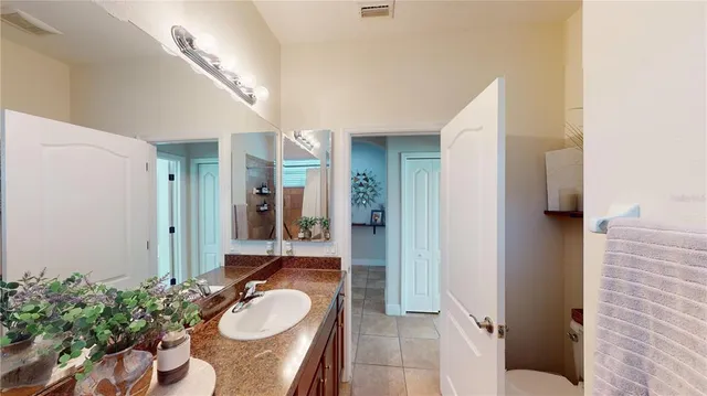 a bathroom with a granite countertop sink and a mirror