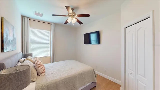 a bedroom with a bed and a chandelier