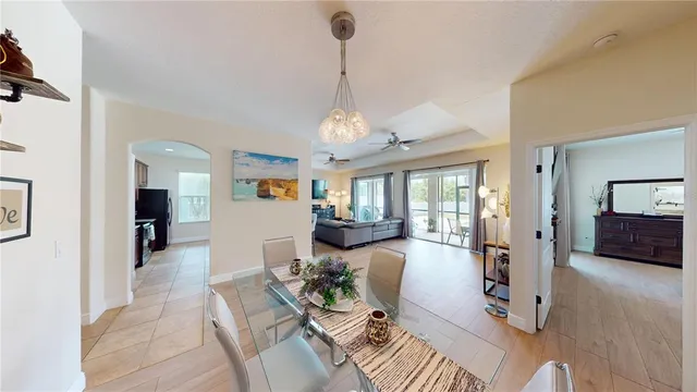 a view of a livingroom with furniture wooden floor and a chandelier