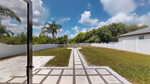 a view of a house with backyard and porch
