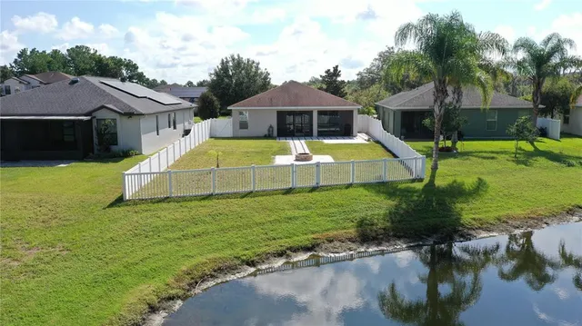 an aerial view of a house with swimming pool lake view and mountain view