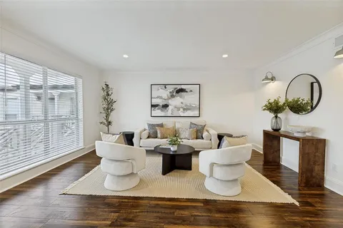 a living room with fireplace furniture and a large window