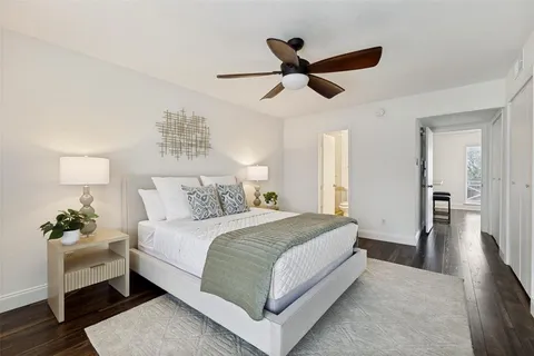 a spacious bedroom with a bed and a chandelier