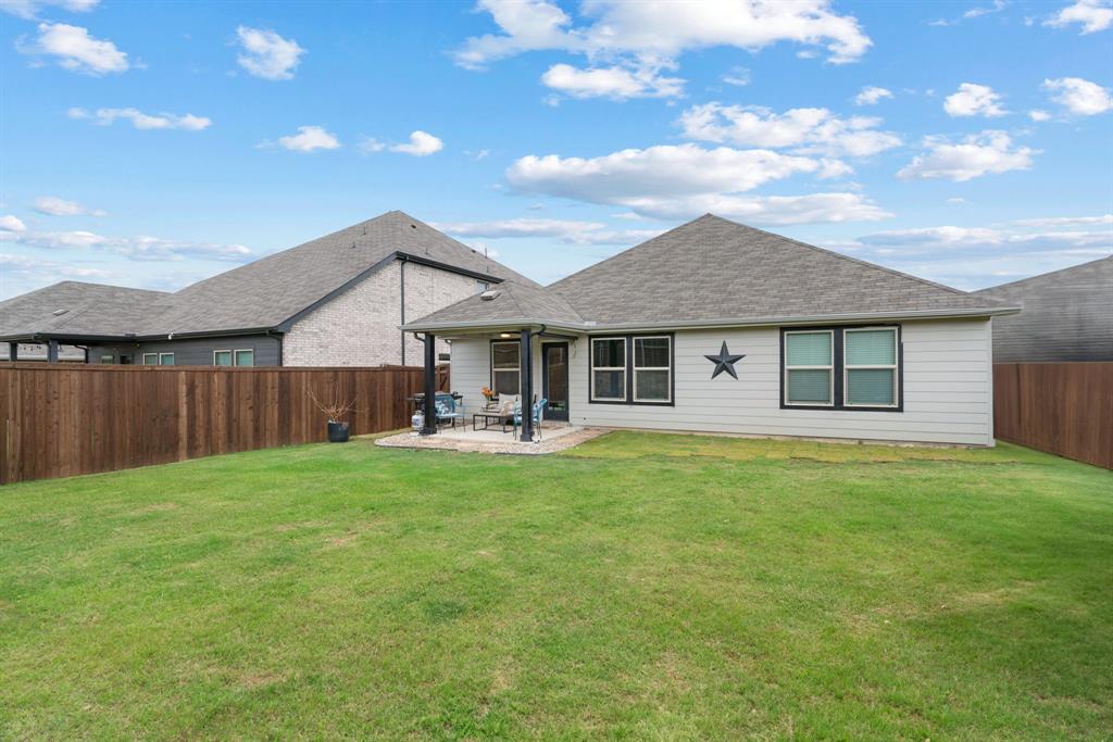 3112 Kingsgarden Road Denton, TX 76207 - Photo 36 of 38 Expansive backyard featuring a large green lawn and a covered patio area