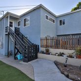 a view of a house with backyard and furniture