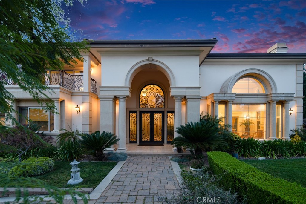 a front view of a house with garden