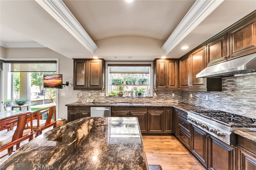 4117 Mt Baldy Road Claremont, CA 91711 - Photo 28 of 75 a kitchen with stainless steel appliances granite countertop sink stove top oven and cabinets