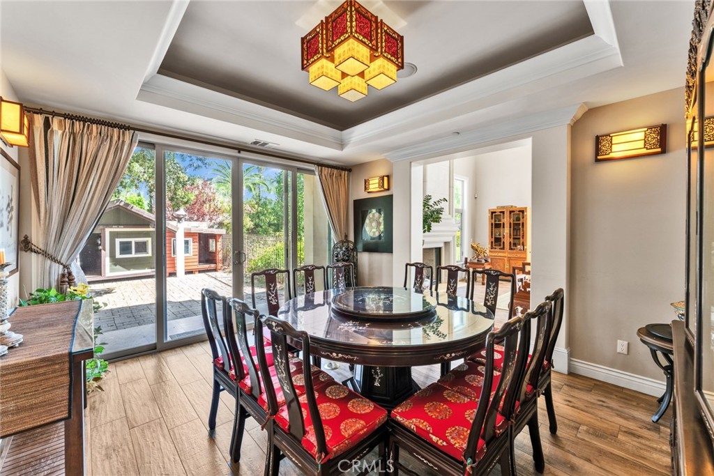 4117 Mt Baldy Road Claremont, CA 91711 - Photo 30 of 75 a view of a dining room with furniture a chandelier and wooden floor