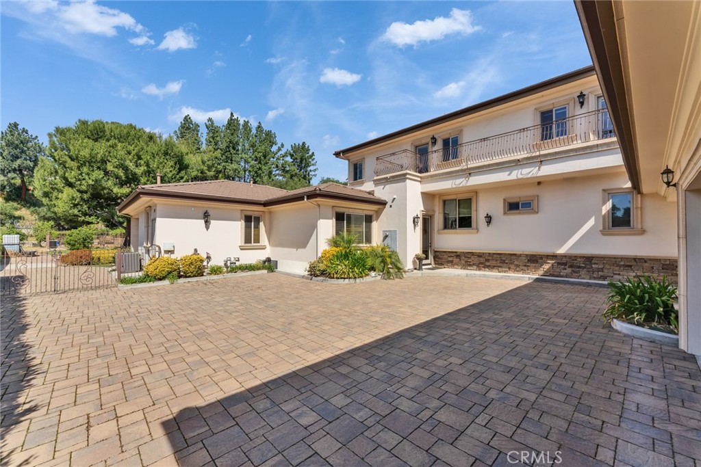4117 Mt Baldy Road Claremont, CA 91711 - Photo 62 of 75 a front view of a house with a yard and a garage